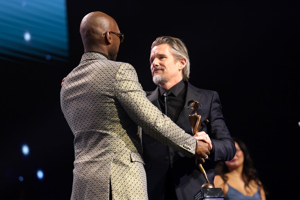 Ethan Hawke accepts the Career Achievement Award from Mahershala Ali at the Palm Springs International Film Awards