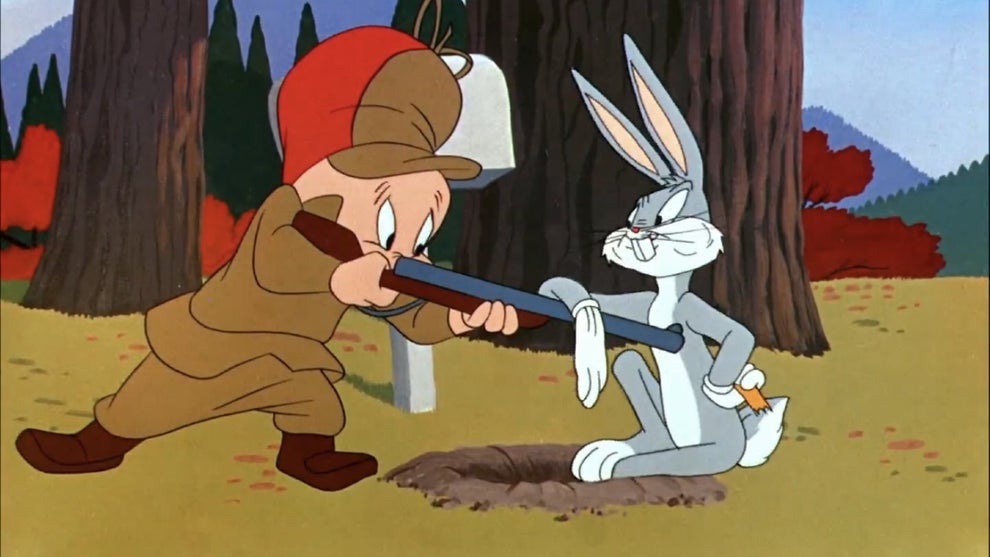 Elmer Fudd points a gun at Bugs Bunny