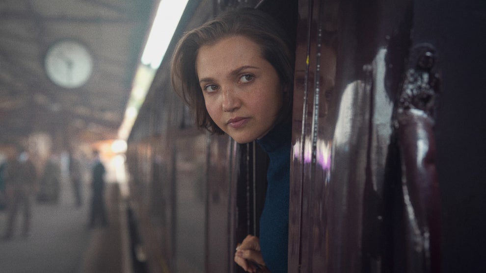 Mia McKenna Bruce leans out of a train in "Seven Dials"
