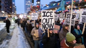 Demonstrators march during the nationwide "Stop ICE Terror" rally through downtown Minneapolis, Minnesota, on January 20, 2026 in protest against US President Donald Trump's policies