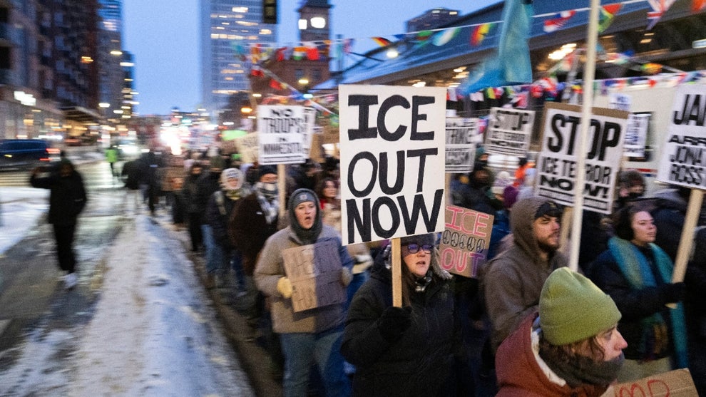 Demonstrators march during the nationwide "Stop ICE Terror" rally through downtown Minneapolis, Minnesota, on January 20, 2026 in protest against US President Donald Trump's policies