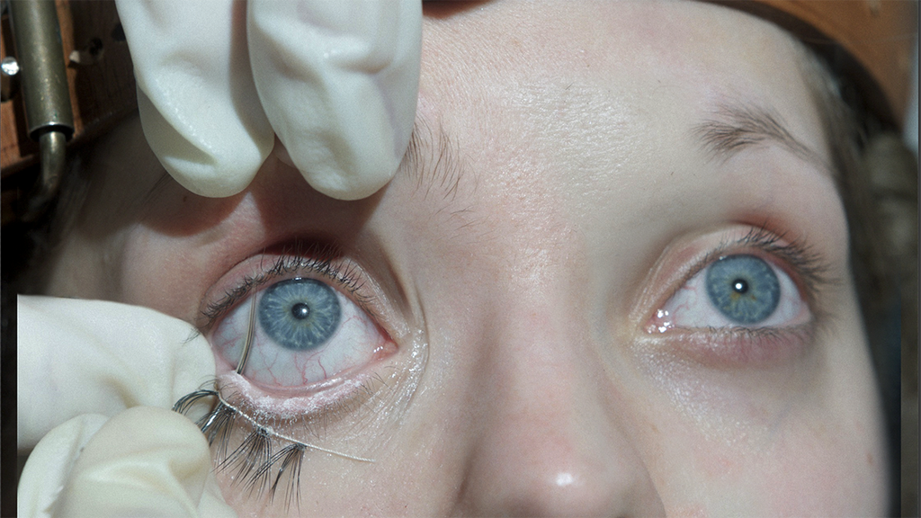 A needle pierces Elvira's (Lea Myren) eye in "The Ugly Stepsister" (Shudder)