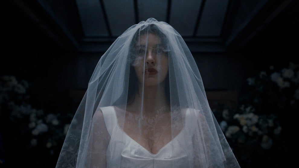 Camila Morrone wears a wedding dress in "Something Very Bad Is Going to Happen" (Netflix)