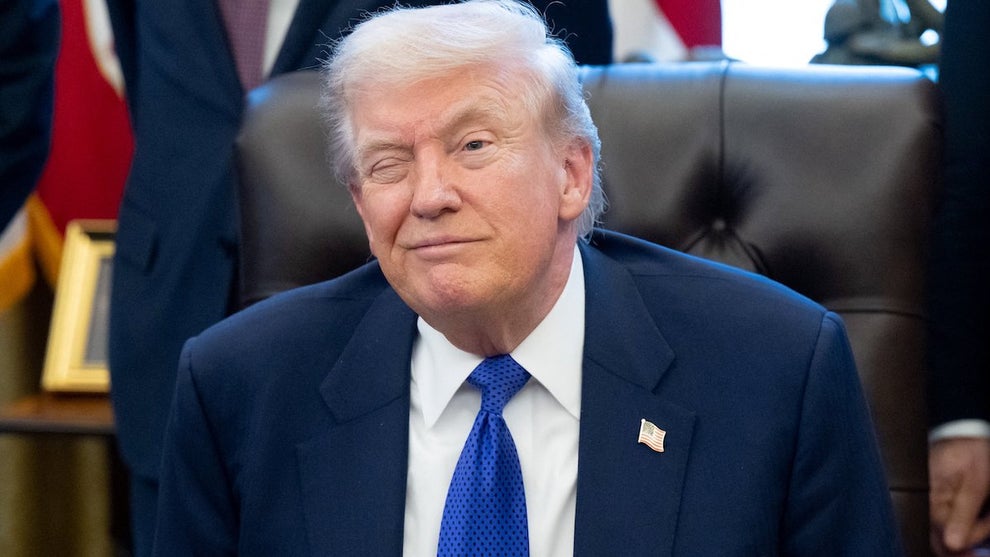 Donald Trump winks as he speaks to the press from the White House on Feb. 2, 2026. (Saul Loeb/AFP via Getty Images)