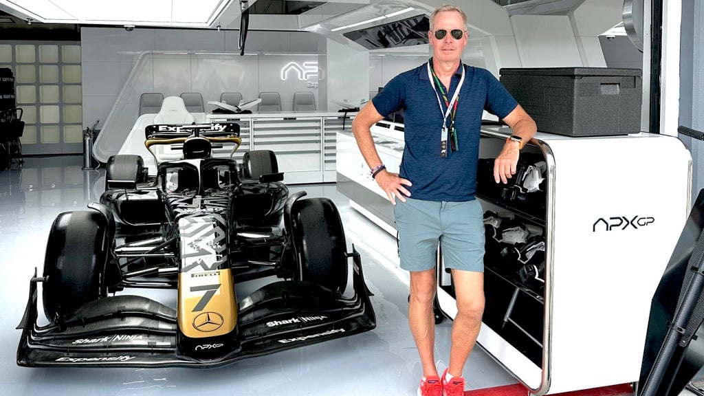 David Leener beside a Formula 1 car