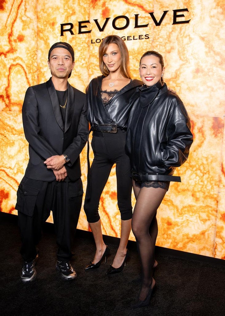 Revolve co-founder Michael Mente; Bella Hadid and Revolve chief brand officer Raissa Gerona, both wearing Revolve Los Angeles, celebrate the collection debut. Source: Revolve/BFA