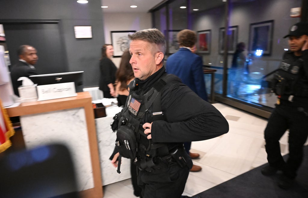 A police officer walks through the lobby of the Washington Hilton after shots were heard during the White House Correspondents' Dinner in Washington, DC, on April 25, 2026. (Photo by Alex WROBLEWSKI / AFP via Getty Images)