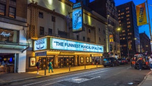 The Eugene O'Neill Theatre on Broadway in New York City, brightly lit with neon signs for "The Book of Mormon.” (Getty Images)