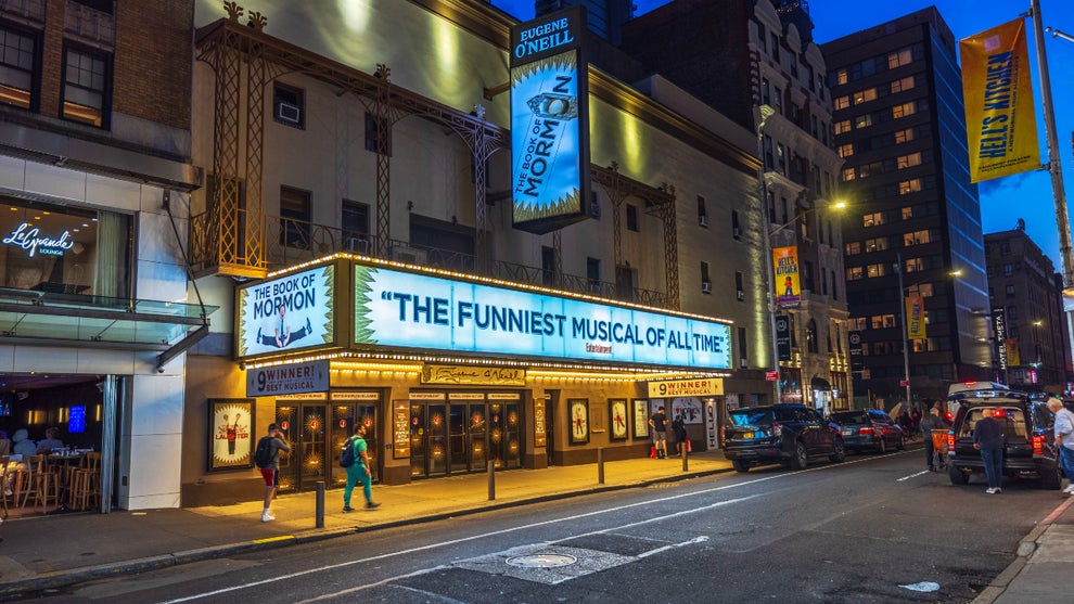 The Eugene O'Neill Theatre on Broadway in New York City, brightly lit with neon signs for "The Book of Mormon.” (Getty Images)