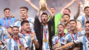 Lionel Messi of Argentina lifts the FIFA World Cup Qatar 2022 winner's trophy on Dec. 18, 2022. (Julian Finney/Getty Images)