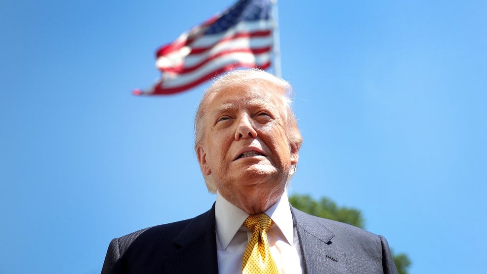 U.S. President Donald Trump speaks in front of the American flag to the press as he departs the White House on May 12, 2026 in Washington, DC
