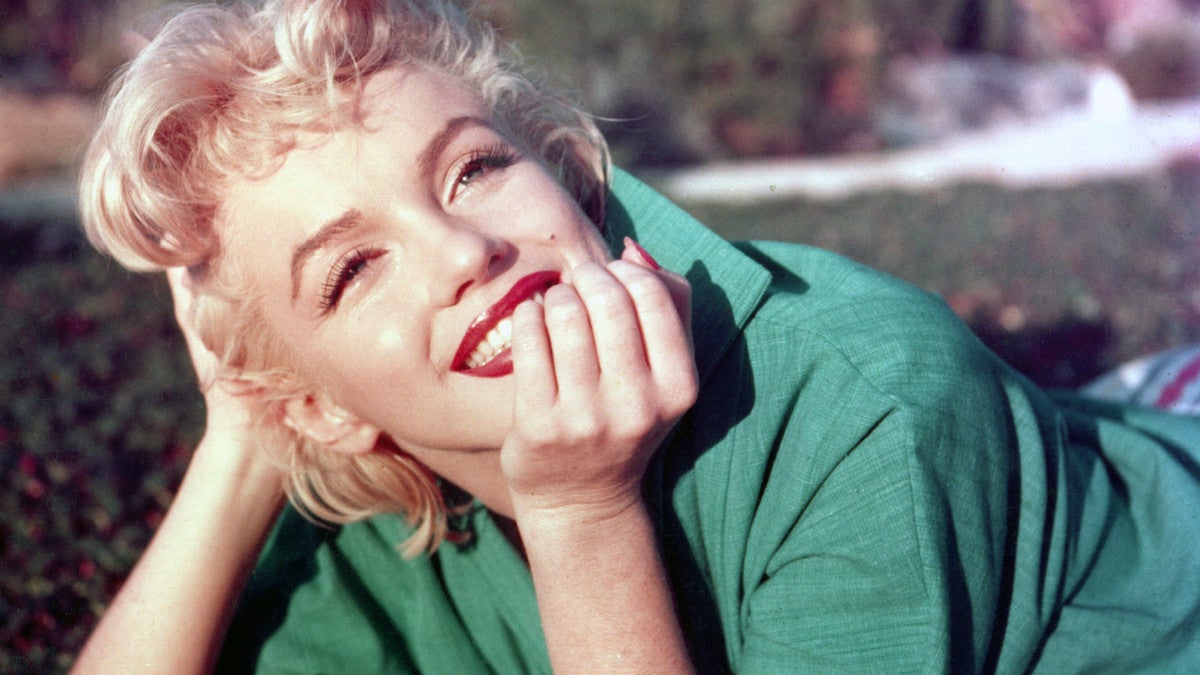 Marilyn Monroe poses for a portrait laying on the grass in 1954 in Palm Springs, California. (Baron/Hulton Archive/Getty Images)