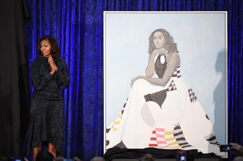 Michelle Obama stands next to her portrait at the Smithsonian National Portrait Gallery on Monday Feb. 12, 2018 in Washington, D.C. Source: Getty