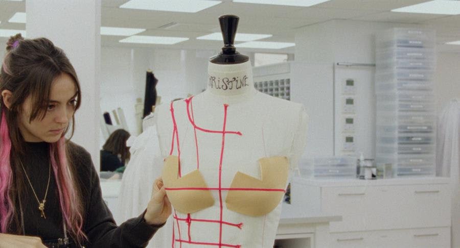 A seamstress (Garance Marillier) works on a dress in Couture . Source: Vertical