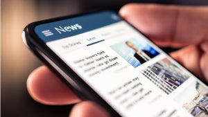 A person reads the news on their mobile phone