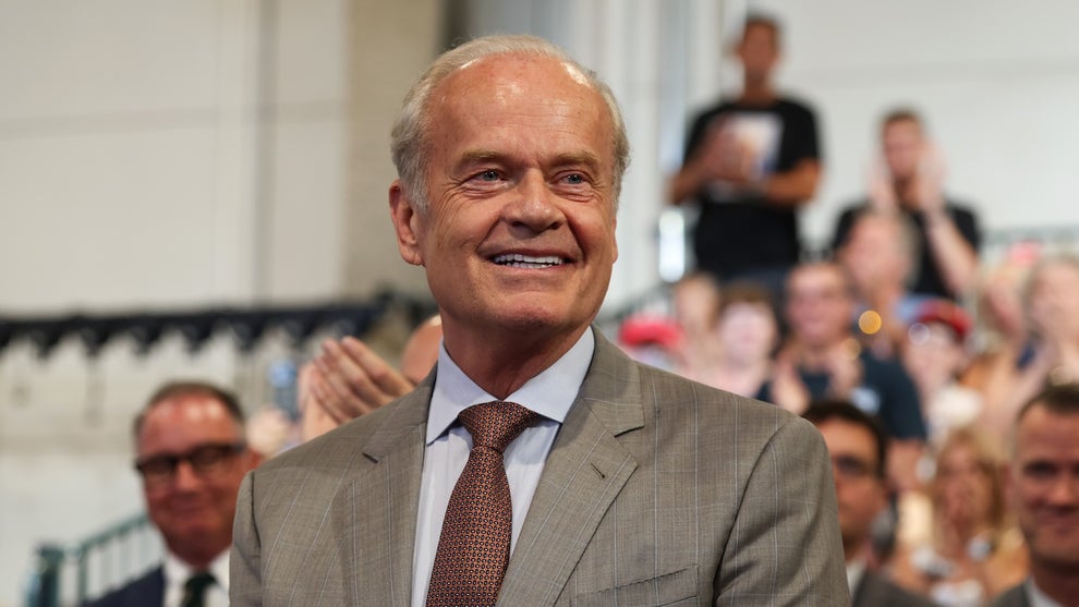 Actor Kelsey Grammer reacts as U.S. President Donald Trump acknowledges him while delivering remarks at the David S. Mack Center for Training and Intelligence on August 14, 2026 in Garden City, New York. (Credit: Samuel Corum/Getty Images)