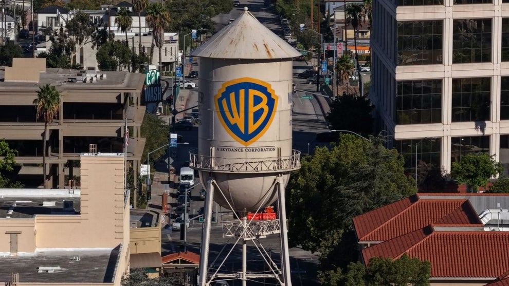 In an aerial view, the Warner Bros. water tower has "A Skydance Corporation" added to it at Warner Bros. Studio on October 06, 2026 in Burbank, California. Paramount Skydance completed its $110 billion acquisition of Warner Bros. Discovery, creating a new global entertainment company called Skydance that combines major film studios, streaming services Paramount+ and HBO Max, and news networks CBS and CNN. (Credit: Justin Sullivan/Getty Images)